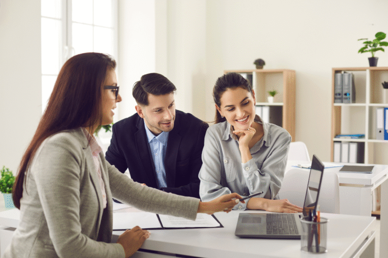 Real estate agent reviewing a home evaluation report with clients at a kitchen table in a GTA home
